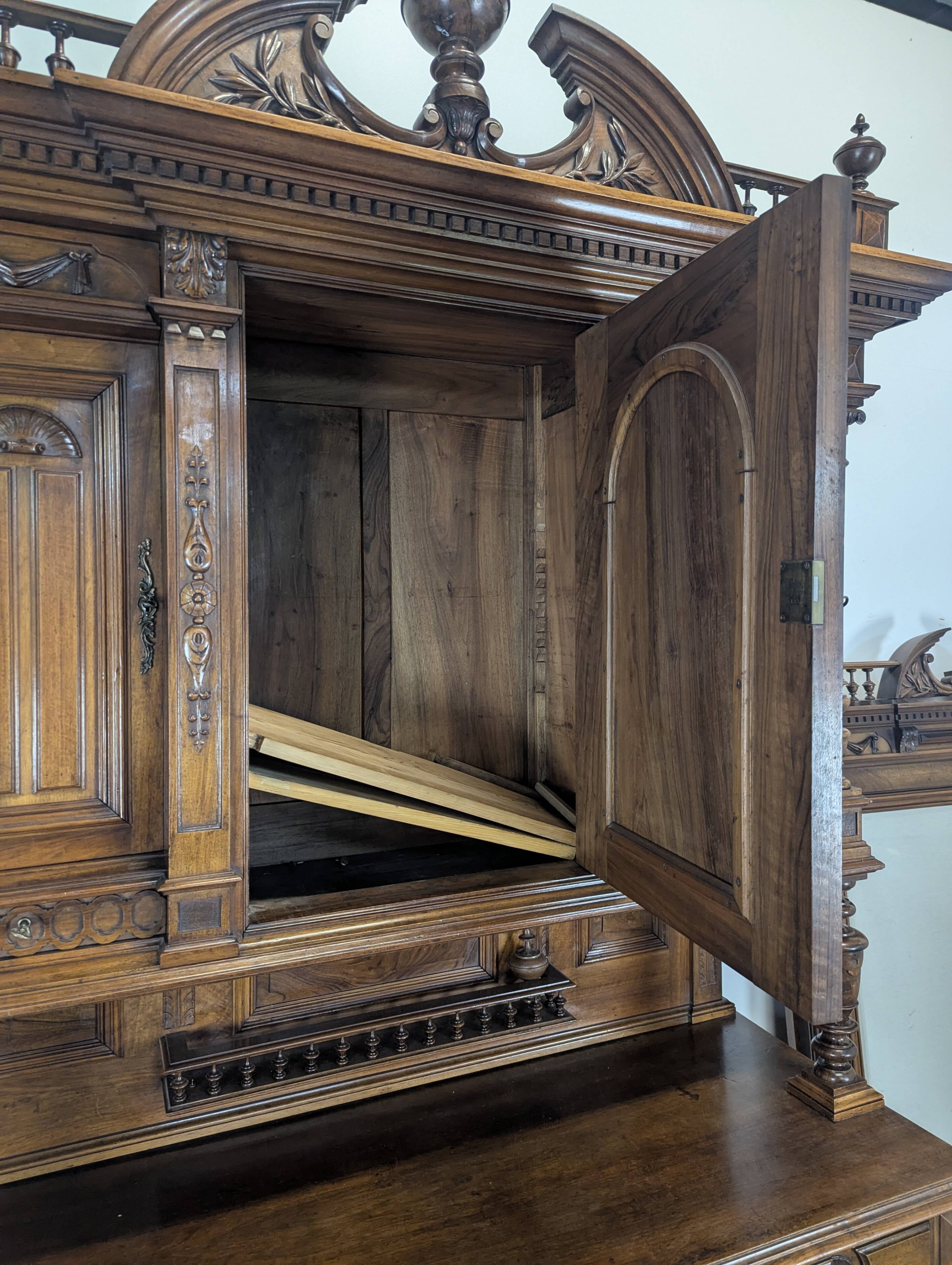 Large buffet with 2 bodies in Renaissance style made of solid walnut.