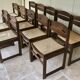 Set of 12 "sledge" dining chairs in walnut and cane.