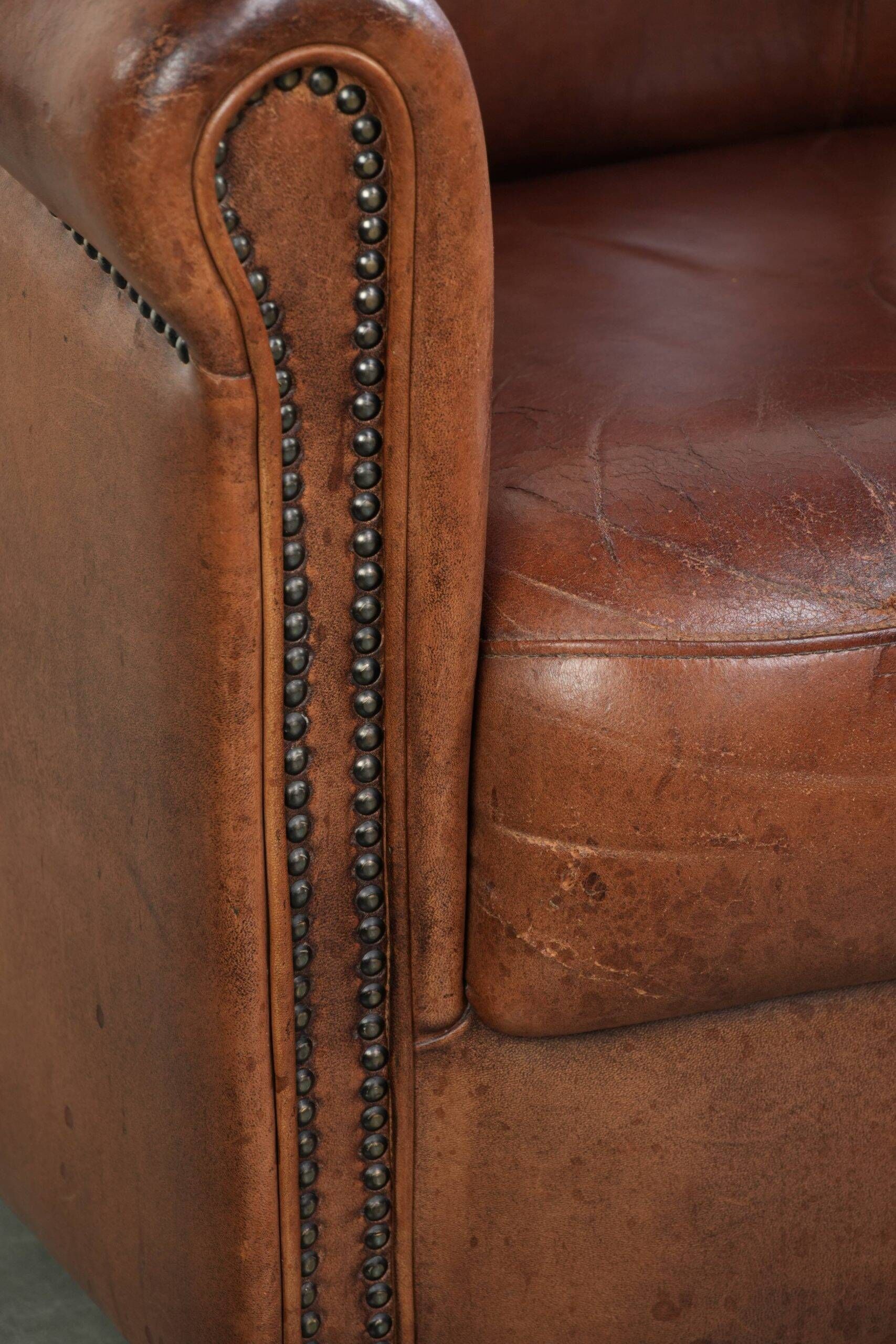 Vintage sheepskin club armchair in English style with deep colours