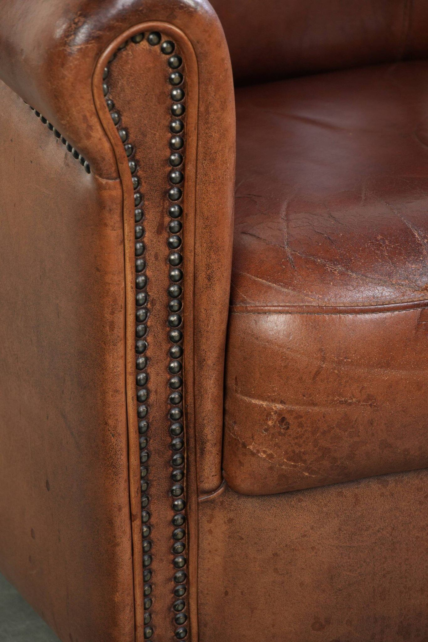 Vintage sheepskin club armchair in English style with deep colours