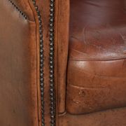 Vintage sheepskin club armchair in English style with deep colours