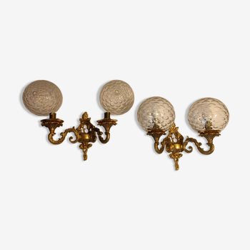 Pair of gilded bronze sconces in Restoration style, glass globes. 1960.