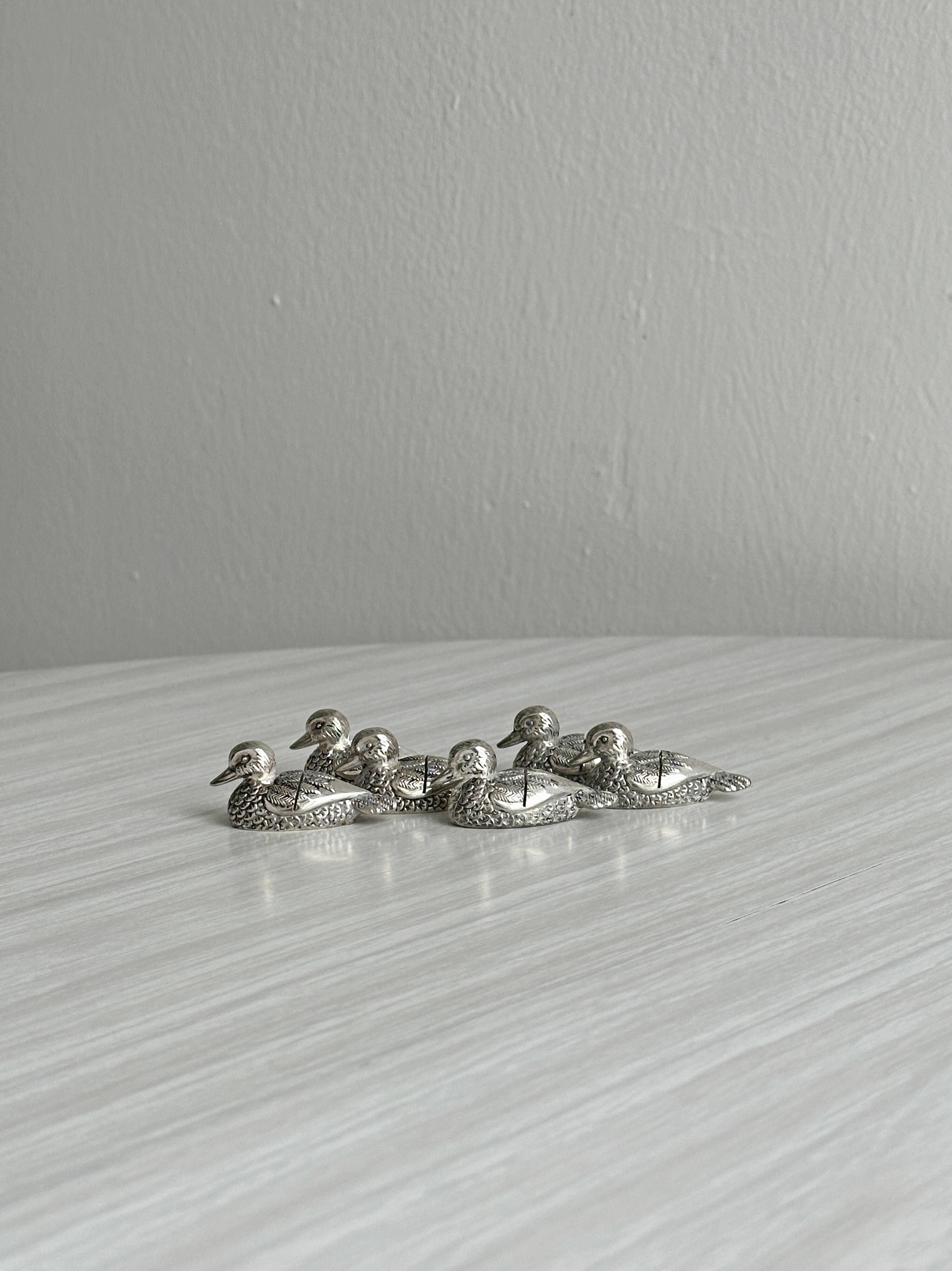 Set of 6 silver-plated metal ducks, name holders and knife rests.