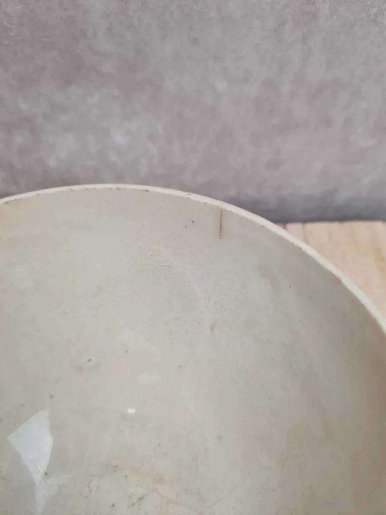 Old ironstone bowl with vintage blue and ochre decoration.