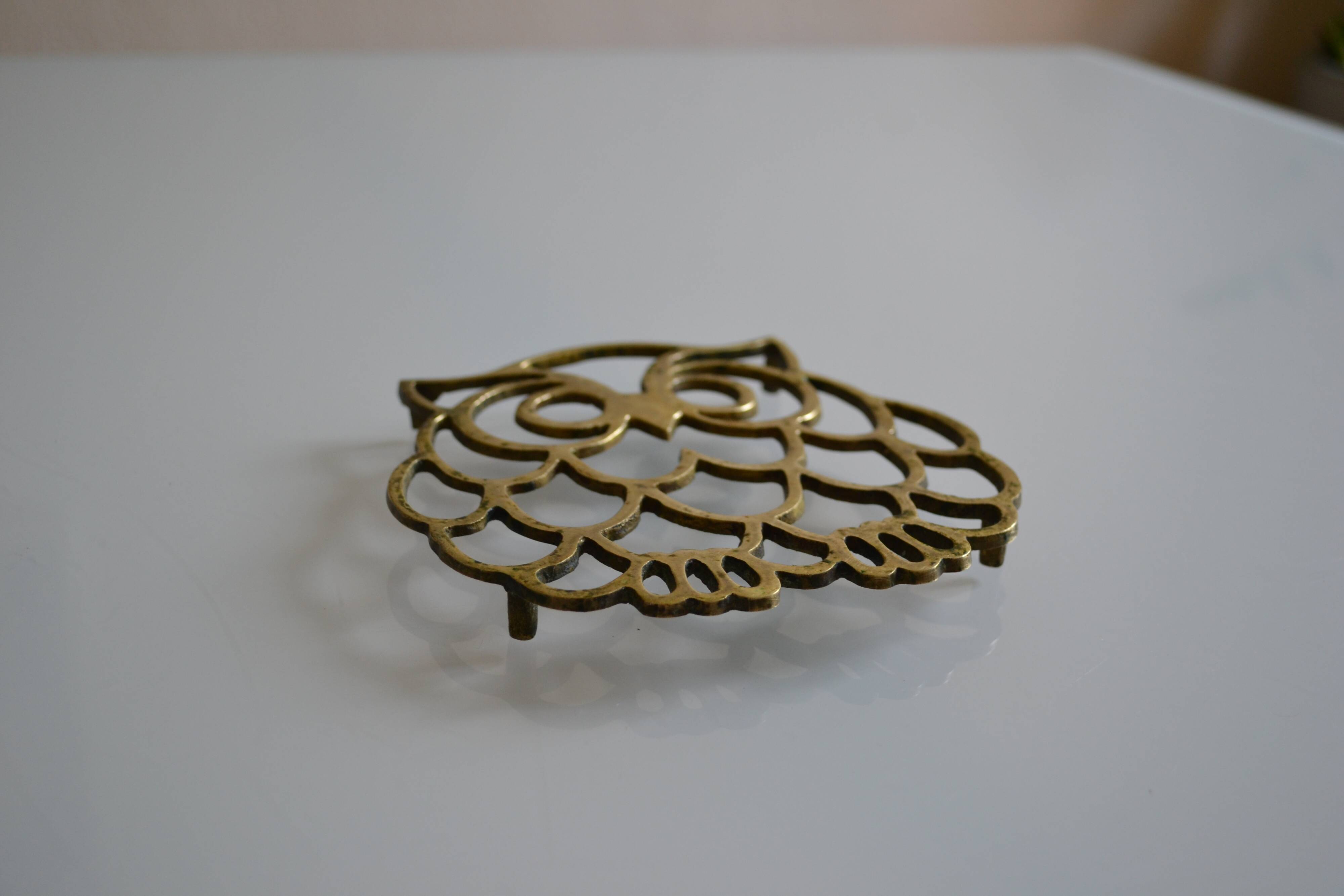 Vintage openwork brass trivet in the shape of an owl or owl