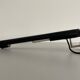 Minimalist black metal wall light with a cylindrical design, 1960s, Germany.