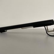 Minimalist black metal wall light with a cylindrical design, 1960s, Germany.