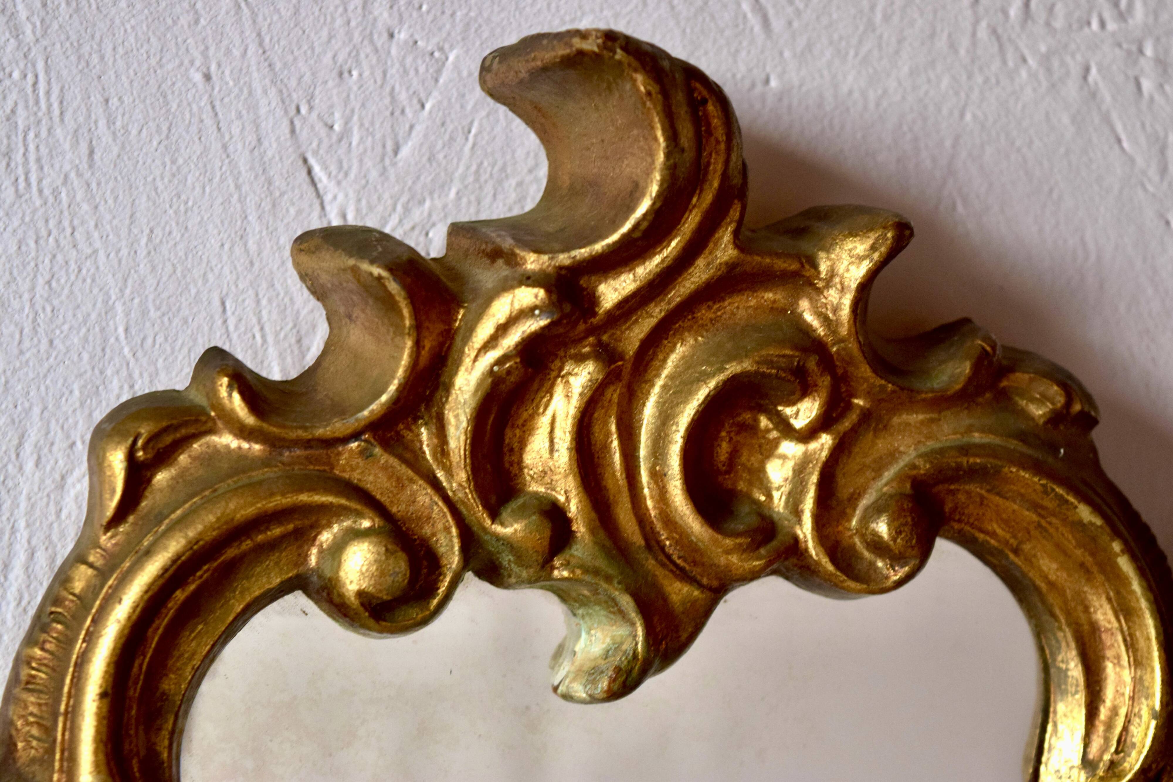 Large rococo mirror in gold painted wood