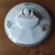 Antique porcelain sugar bowl with a decagonal base.