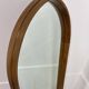 Miroir à tablette cerclage bois, forme ogive, années 60
