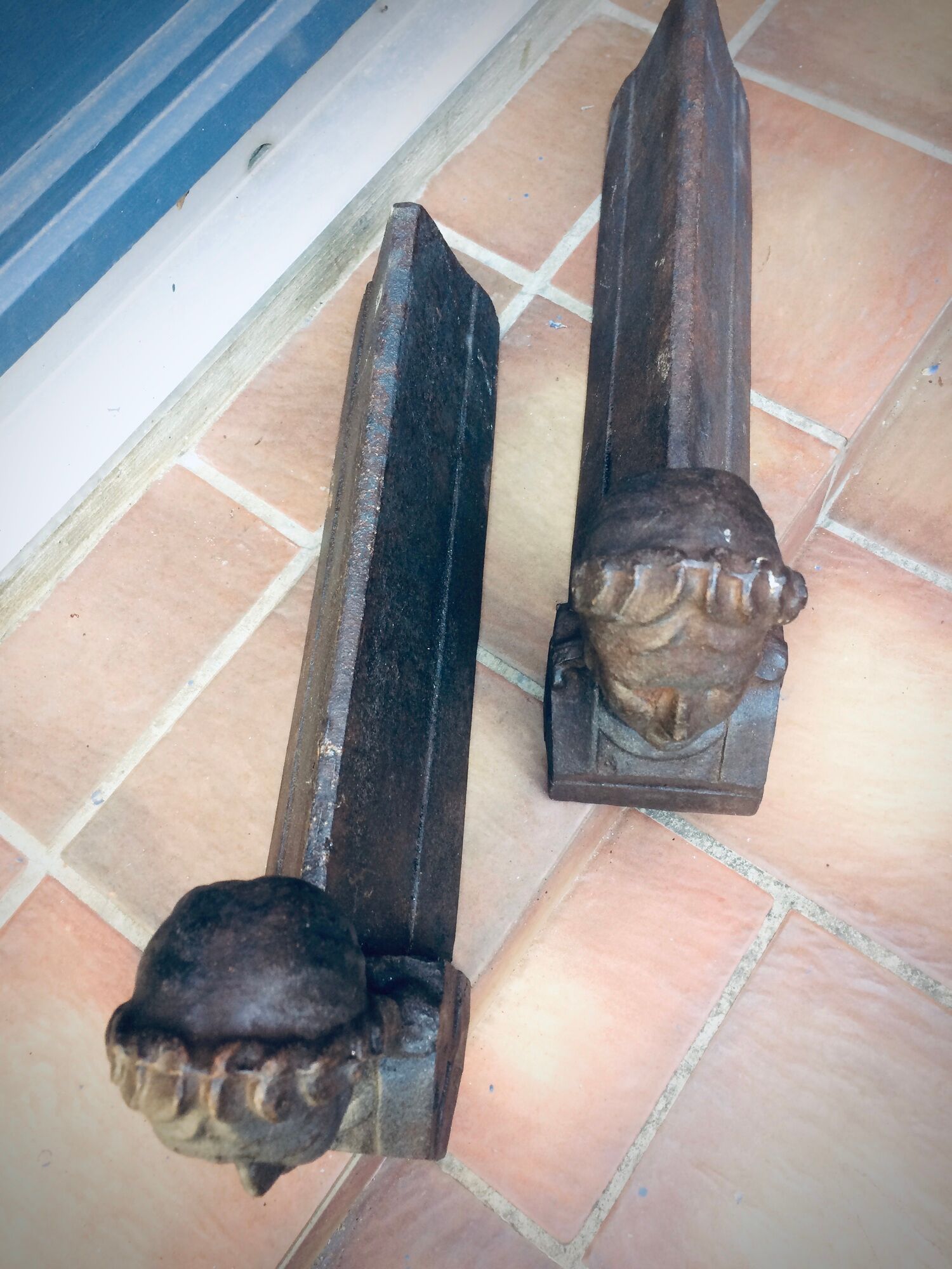 Pair of cast-iron chenet characters with laurels