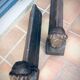 Pair of cast-iron chenet characters with laurels
