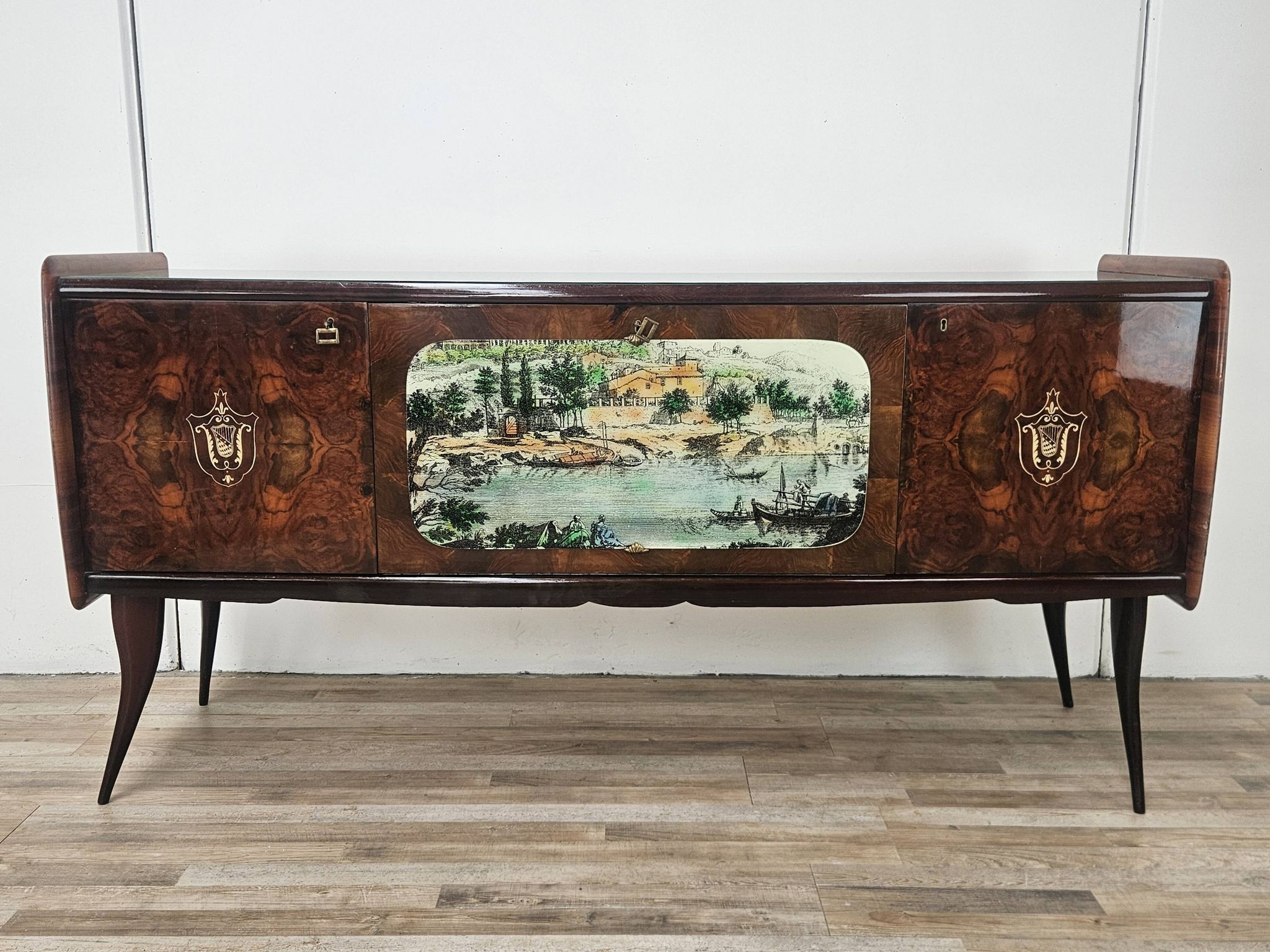 1950s mahogany sideboard with a glass top and central bar.