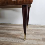 Mid-century drawer chest in mahogany, brass and glass.