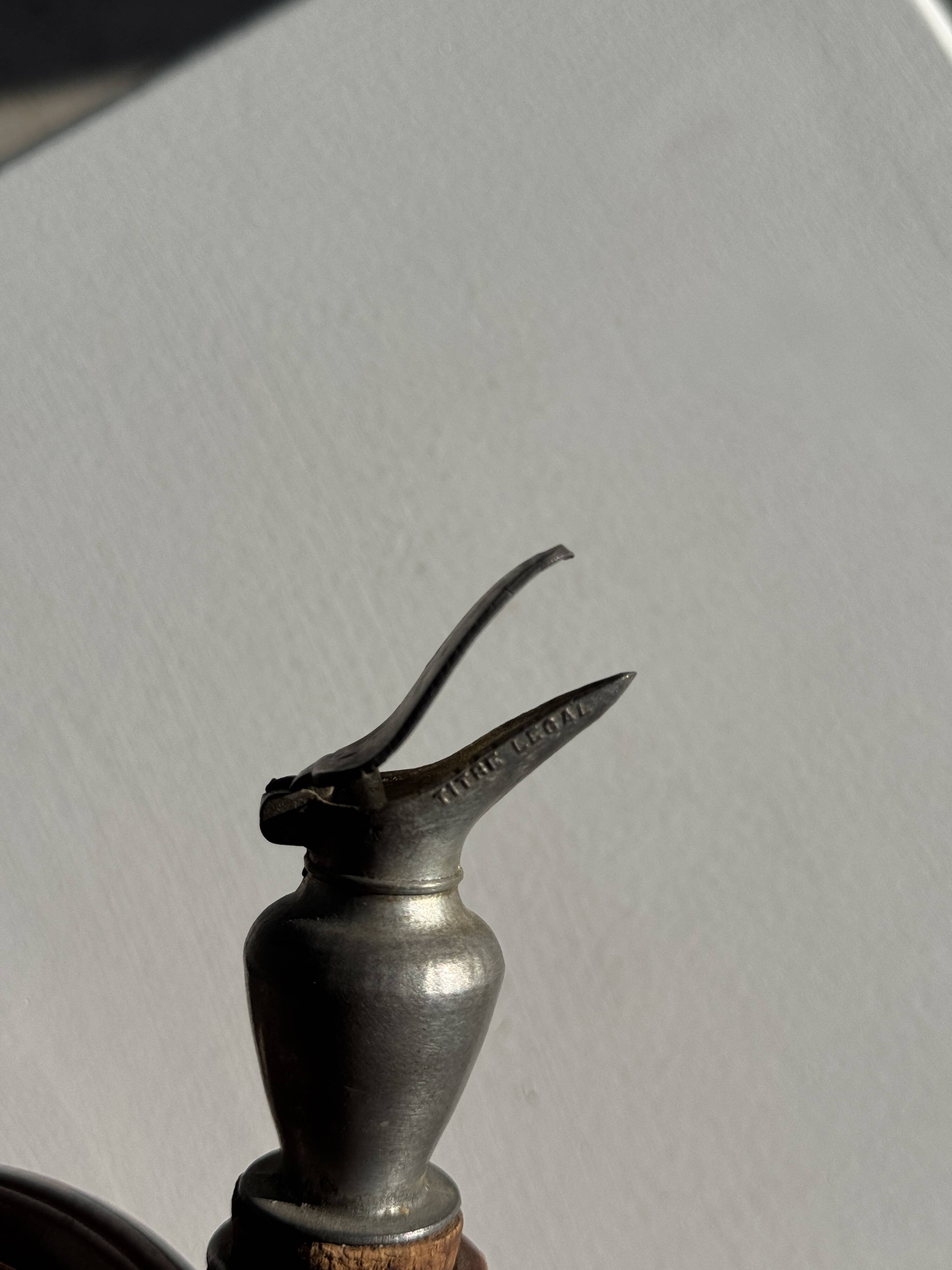 Ancient stoneware jug with a pewter spout.