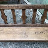 Duo of old solid oak benches with backs and armrests.