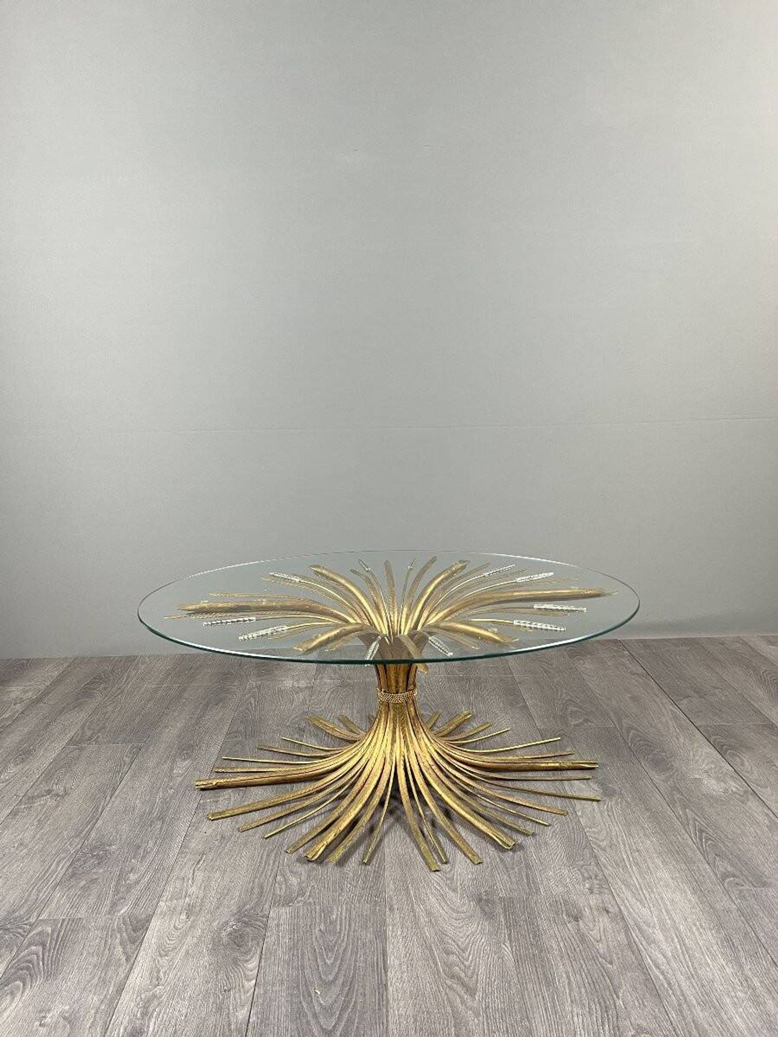 Gold metal and glass coffee table, 20th century, in the style of Robert Goos.