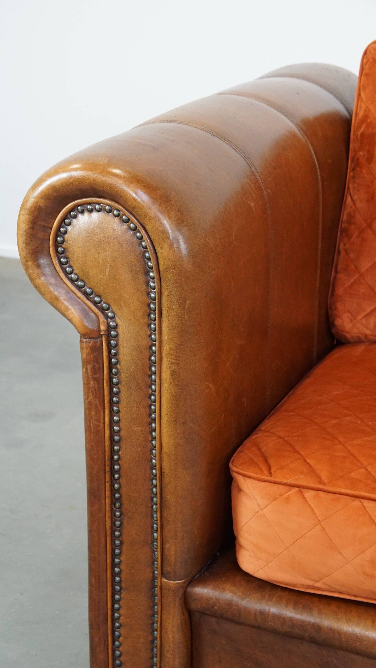 Luxury and comfortable sheepskin 2.5-seater sofa of top quality with orange fabric seat and back cushions