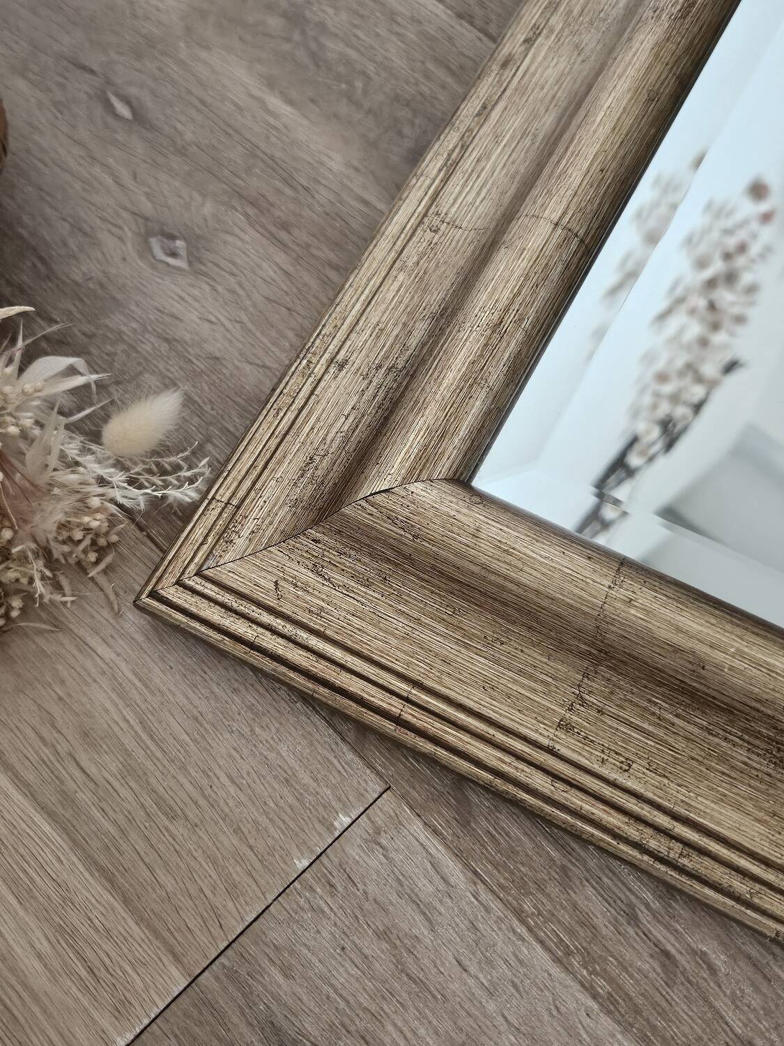 Beveled mirror under gold frame