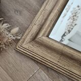 Beveled mirror under gold frame