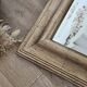 Beveled mirror under gold frame