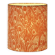 Lampshade covered with a decorative translucent fabric featuring a peacock pattern.