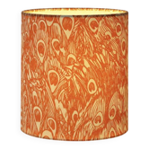 Lampshade covered with a decorative translucent fabric featuring a peacock pattern.