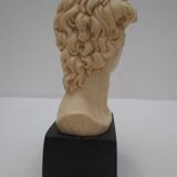 Small glass globe on base housing a figurine of “david”