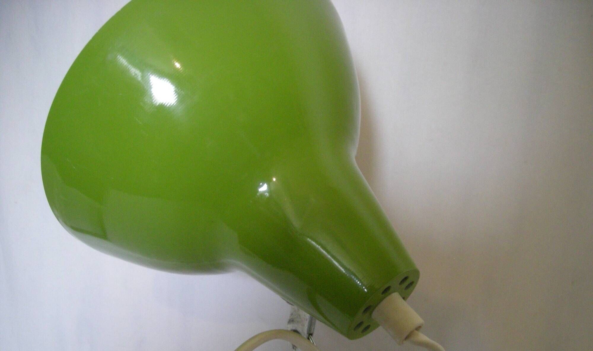 Green desk lamp with an arm from the 1970s.