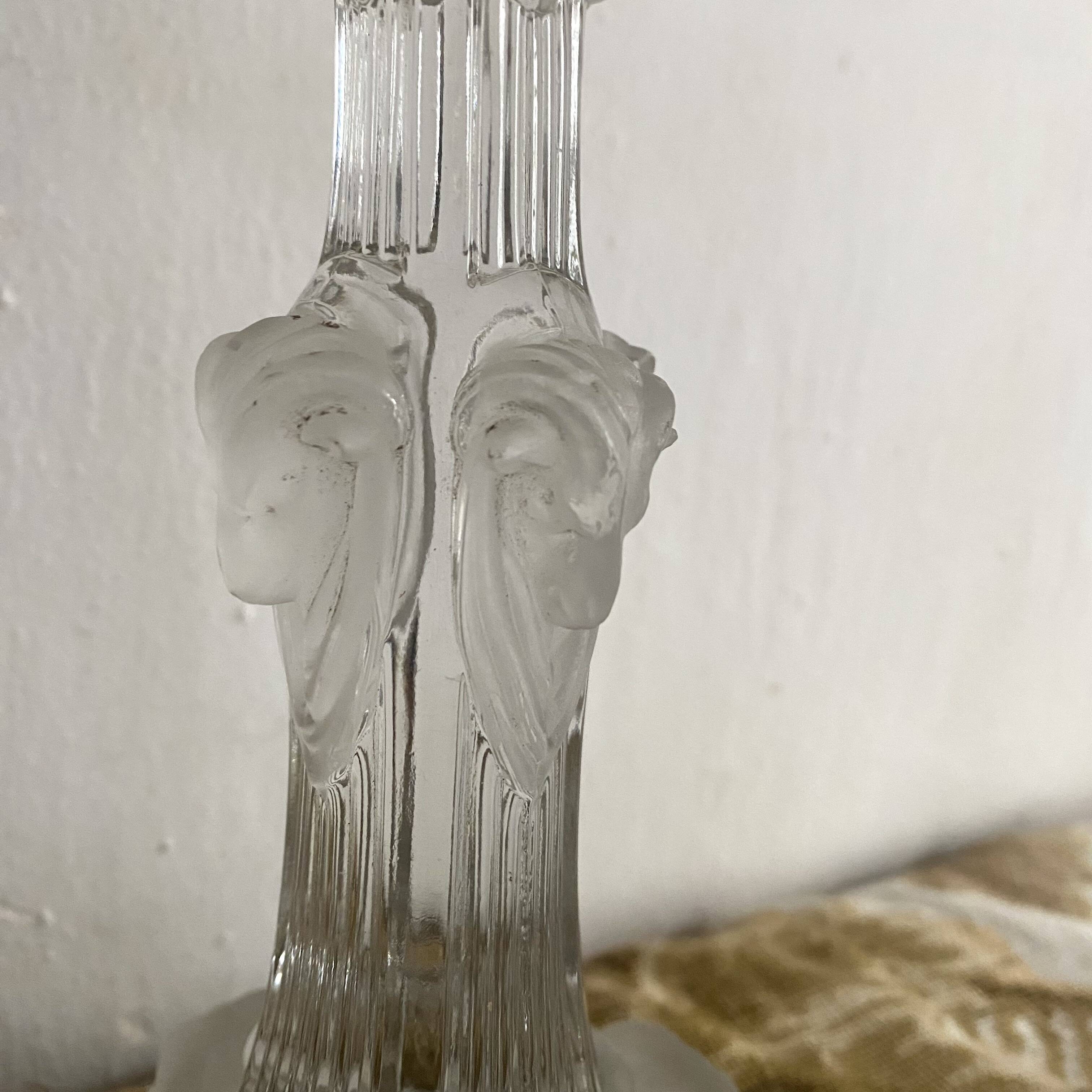 Pair of moulded glass candlesticks, ram heads and masks
