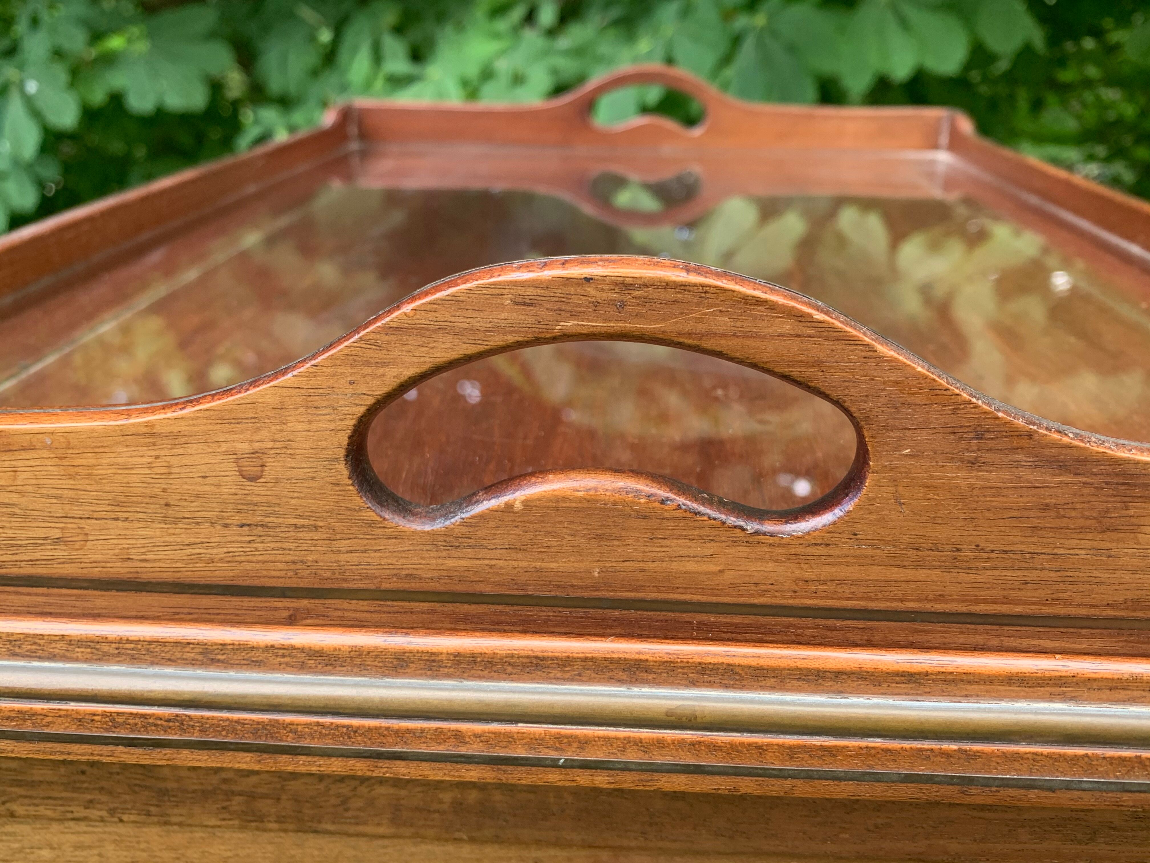 Glass-enclosed old tea table with wooden tray, bronze and brass