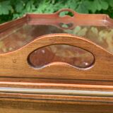 Glass-enclosed old tea table with wooden tray, bronze and brass