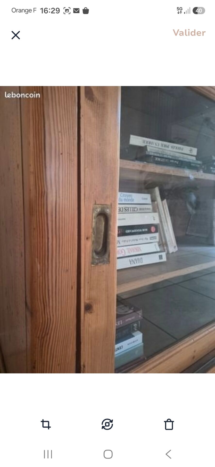 Antique wooden sideboard with three sliding glass doors.