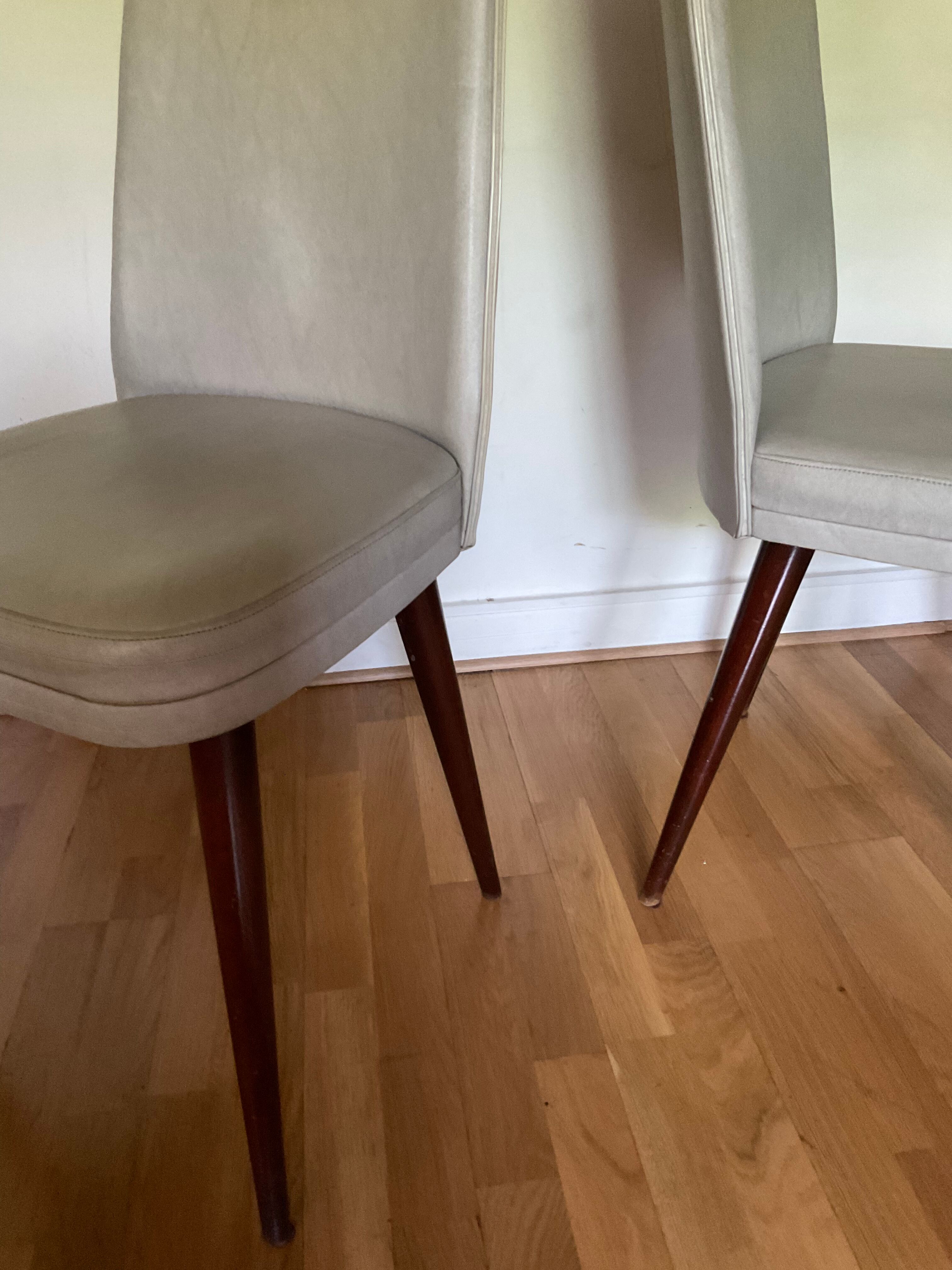 Pair of vintage mahogany and skai chairs