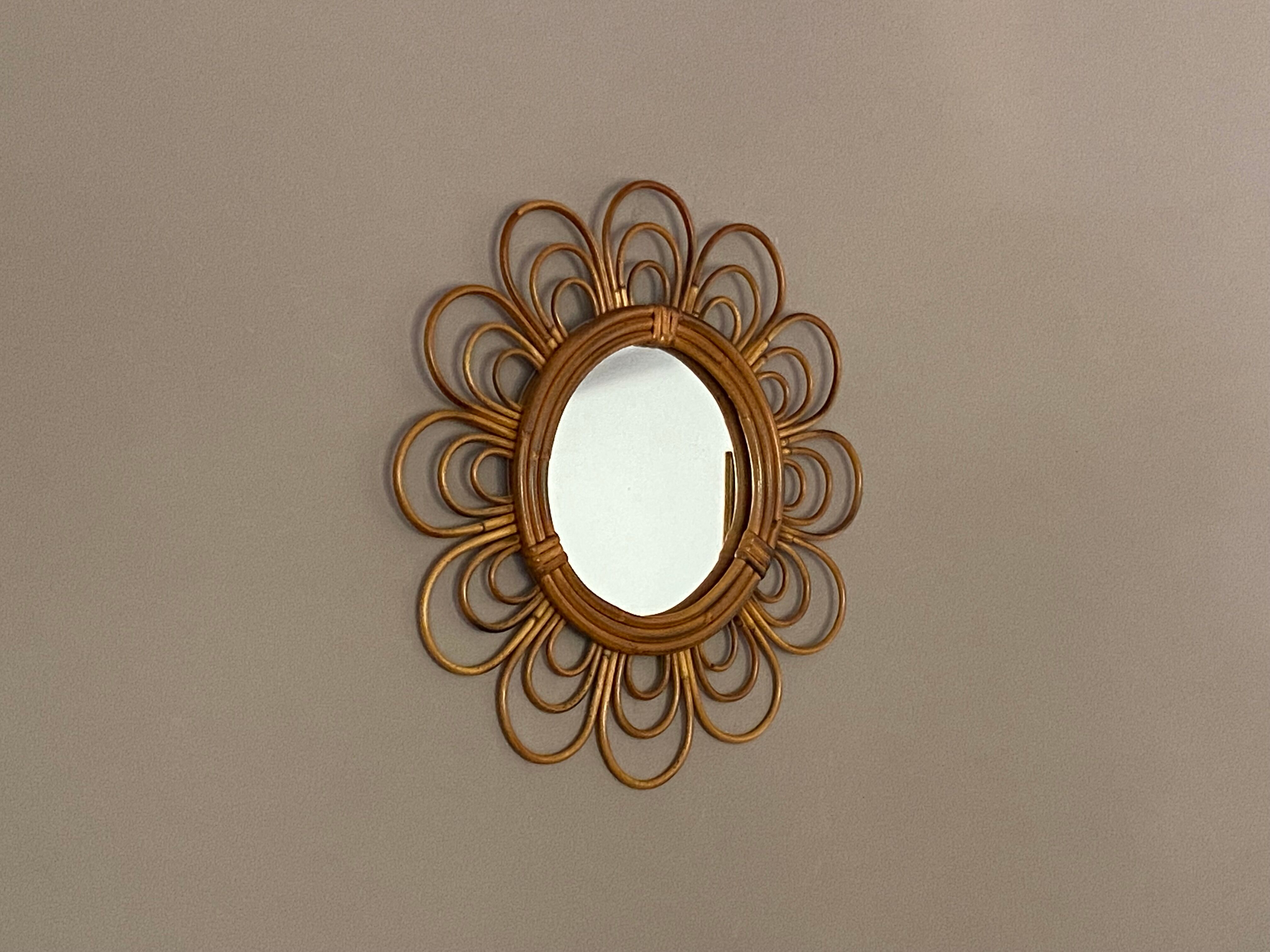 Sun mirror in arched rattan. 40cm. 1960.