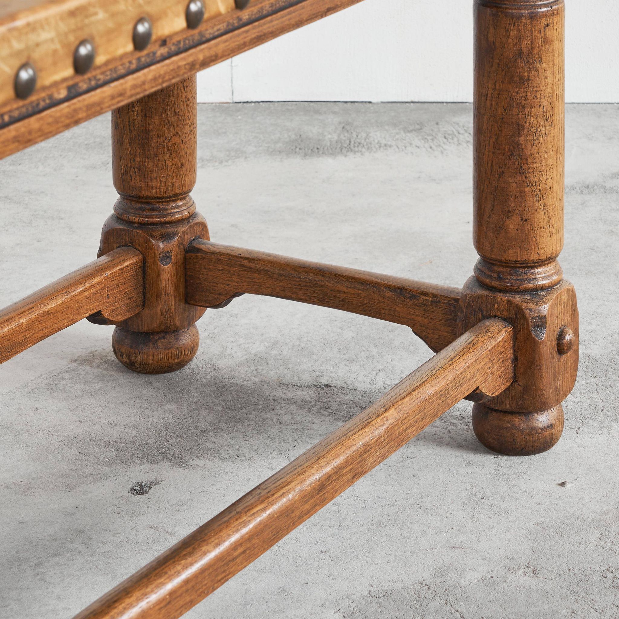 Brutalist coffee table in solid oak, metal, and patinated leather, 1940s.