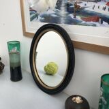 black and gold oval mirror
