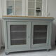 Vintage buffet on grey green wheels, 2 glass doors, wooden tray.