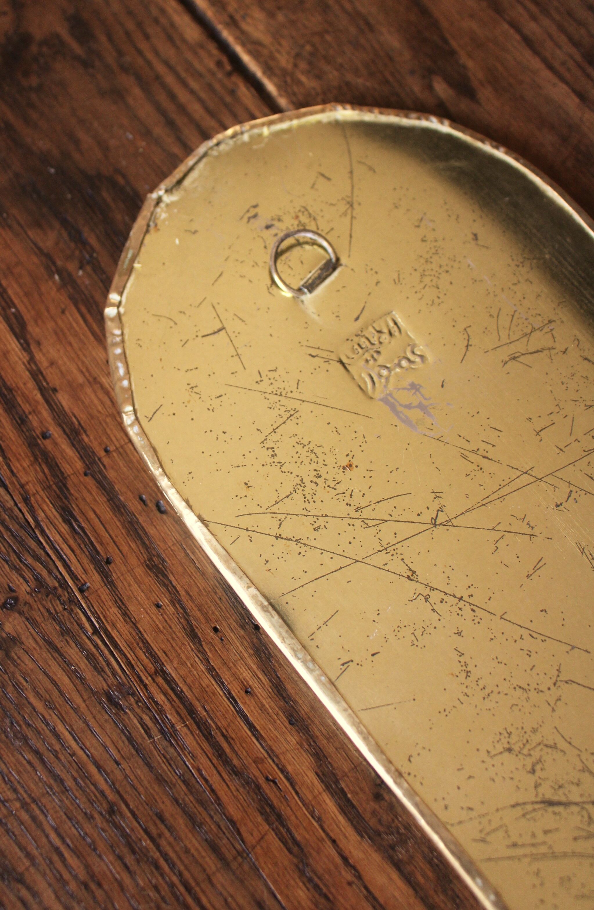 Rounded brass mirror