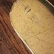 Rounded brass mirror