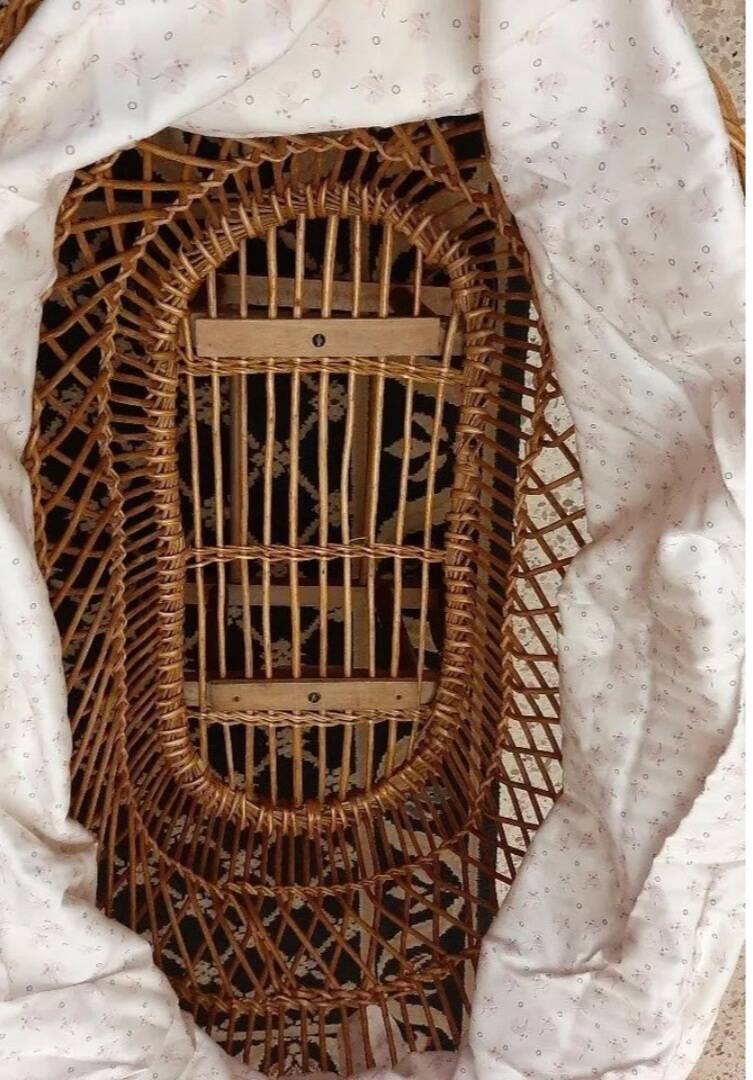 Vintage wicker cradle on wheels from the 1970s.