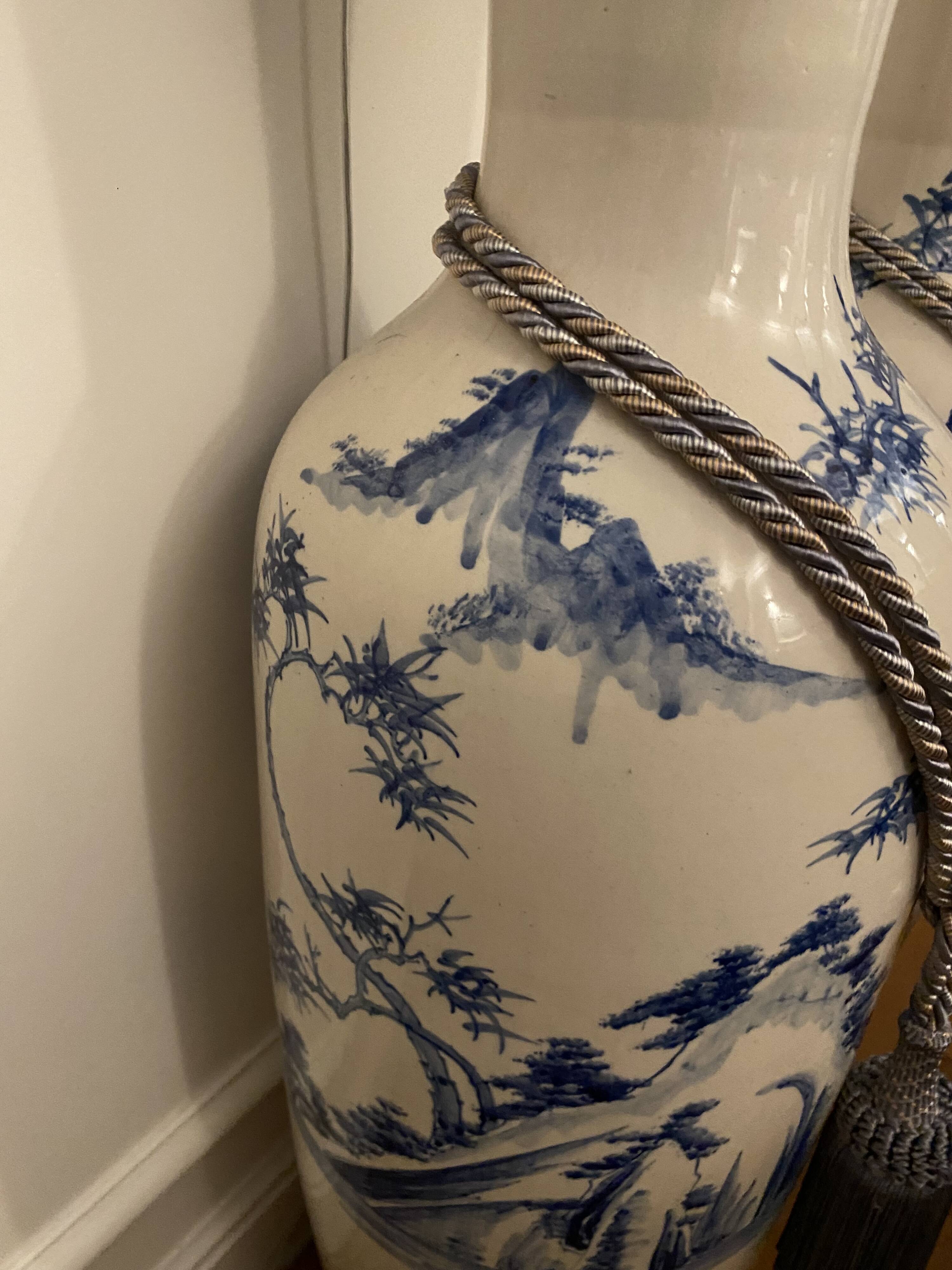 Set of two very large white and blue ceramic vases.