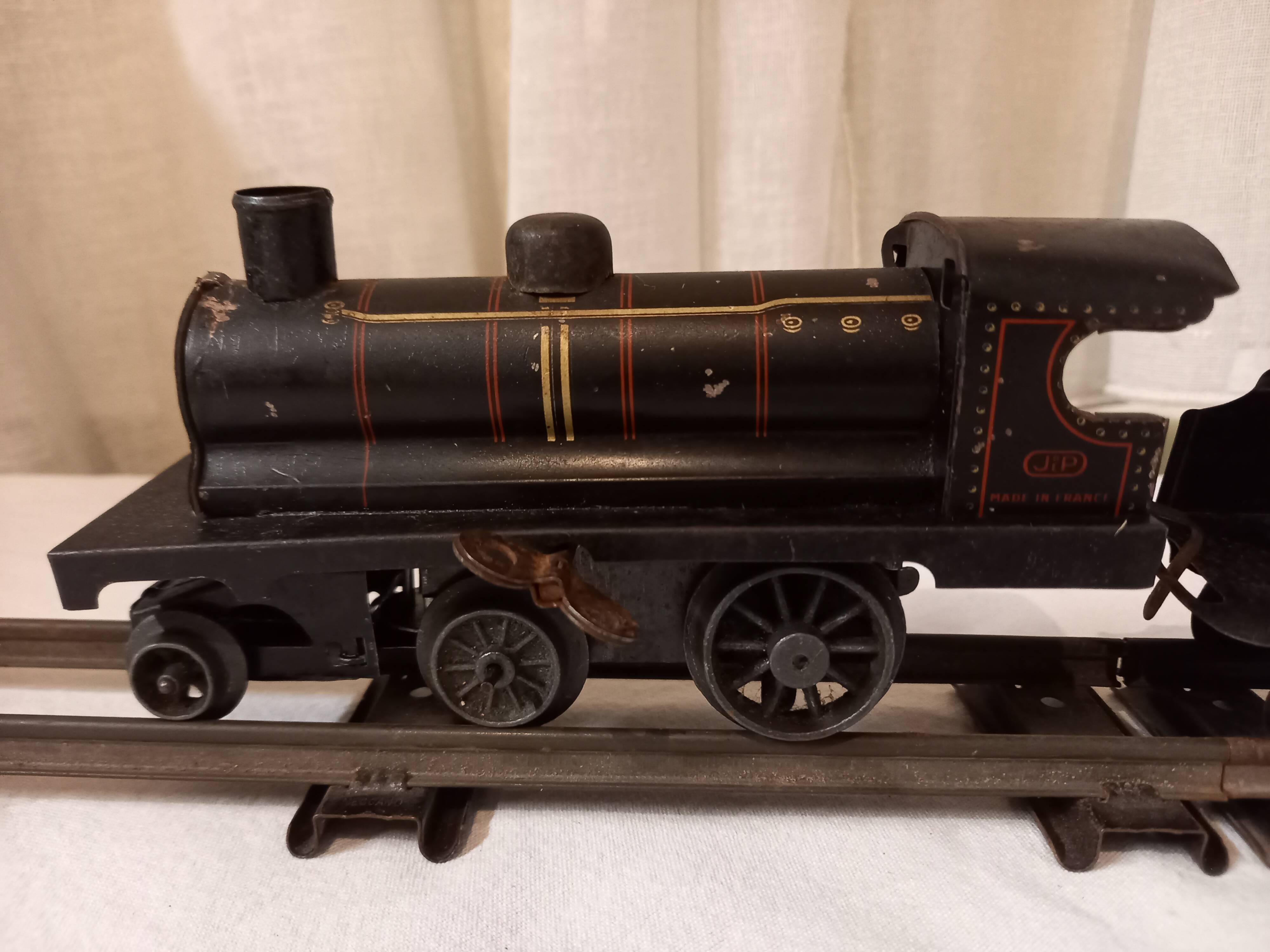 Small JEP mechanical train, including locomotive, tender, sleeping car, rail, 1930s