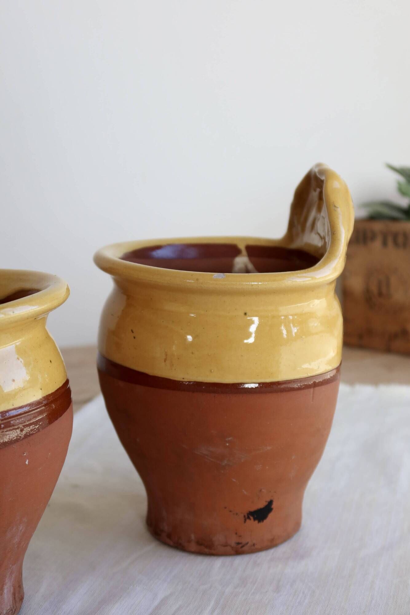 Pair of vintage wall planters in yellow glazed stoneware.