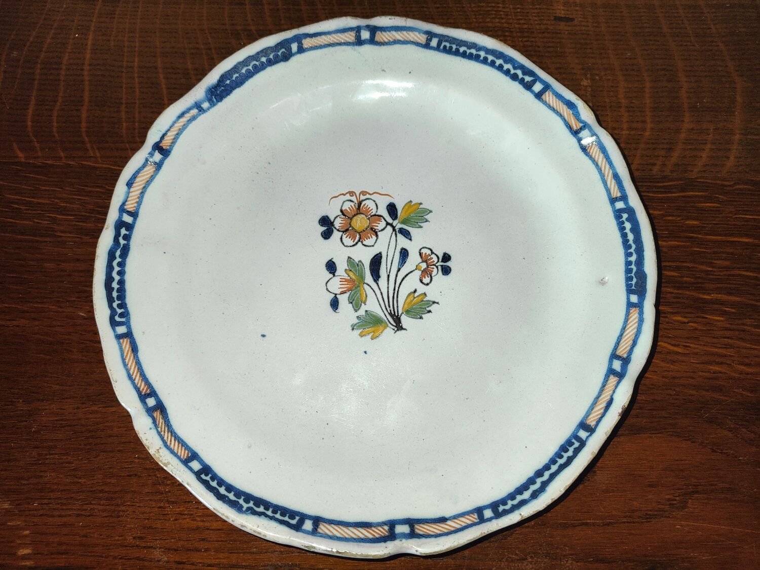 Old earthenware plate of the North XVIIIth Century with floral decoration