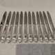 12 silver-plated metal table knives, Platil rocaille silversmith design, 24.6cm