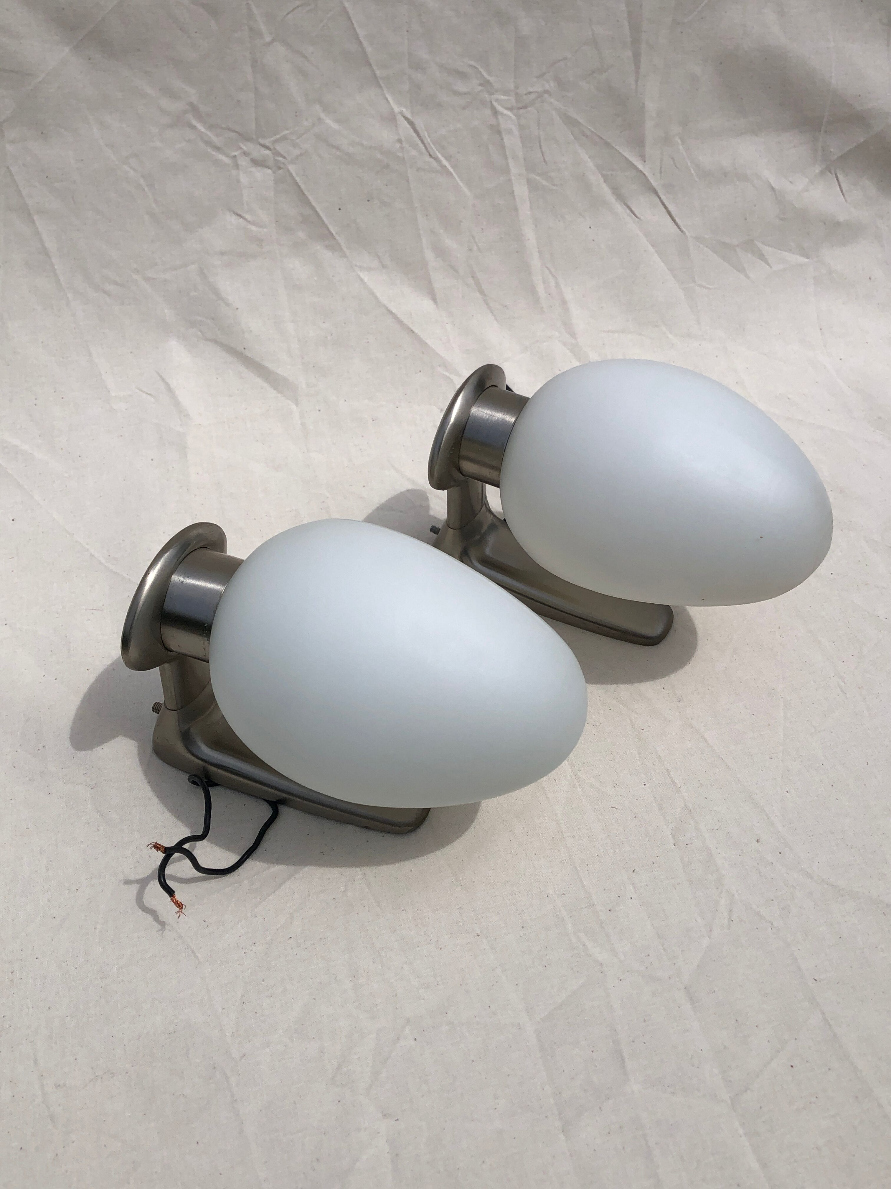 Pair of brushed steel appliques, half-egg opaline, 1970