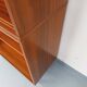 Vintage wooden bookshelf in teak style from the 1960s.