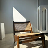 Reclined armchair in canned teak in natural wood
