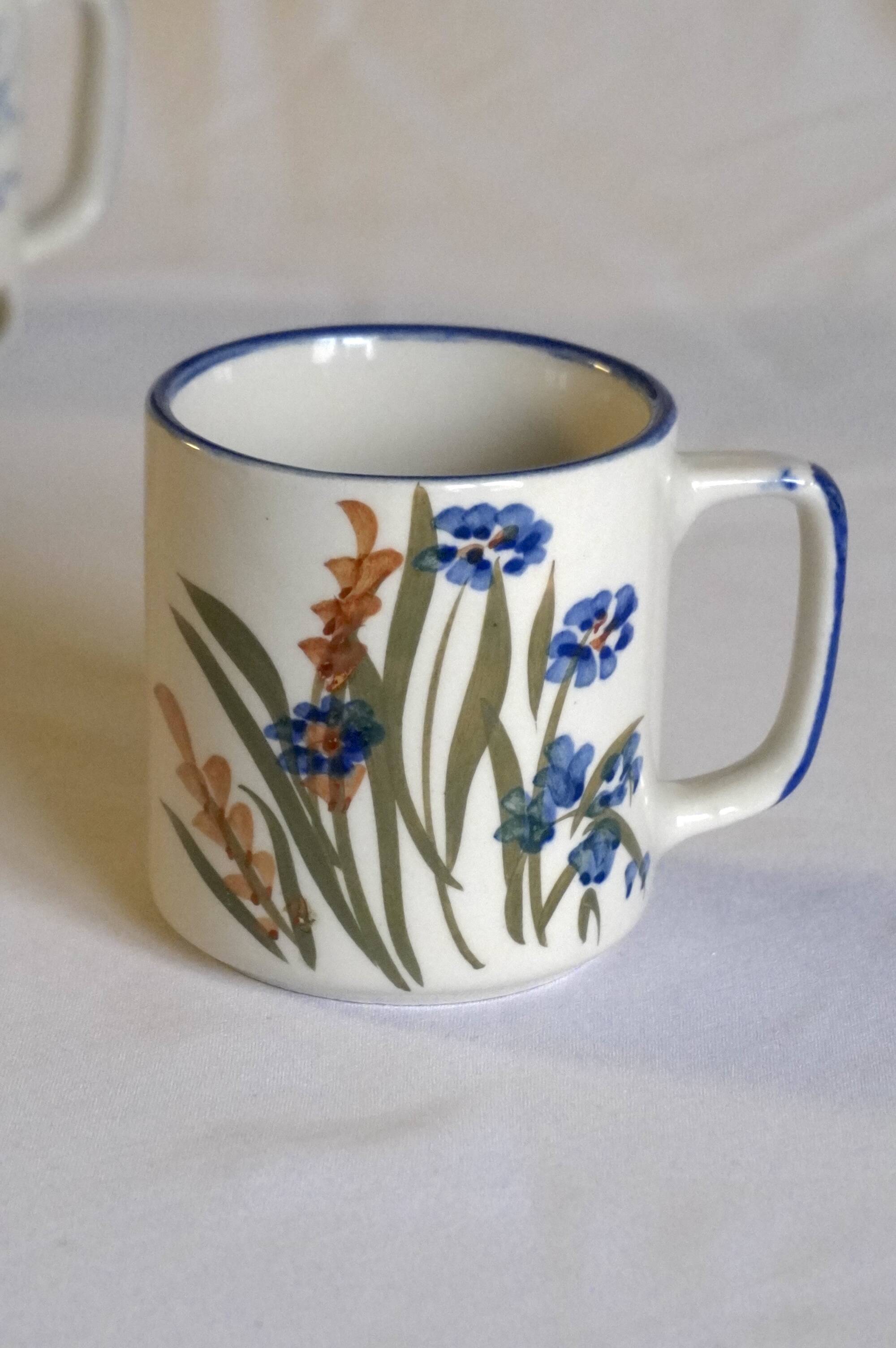 Set of 4 stoneware cups/mugs with blue floral designs, made in China.